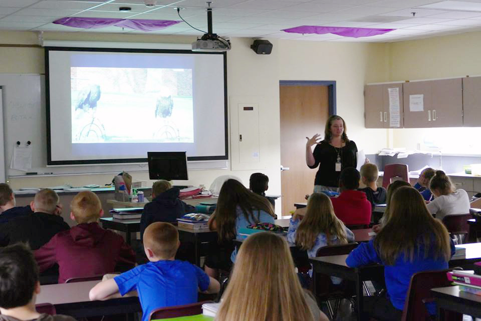 Teacher in a classroom projecting a RaptorLab lesson to teach her kids