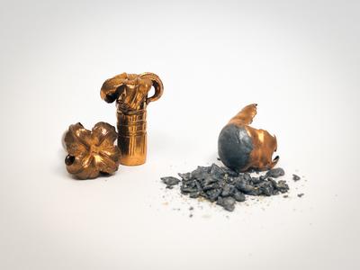 Left: A spent lead bullet with lead fragmentation debris. Right: A spent copper bullet with no fragmentation