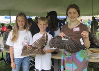 Three children attending a Youth Raptor Corps event