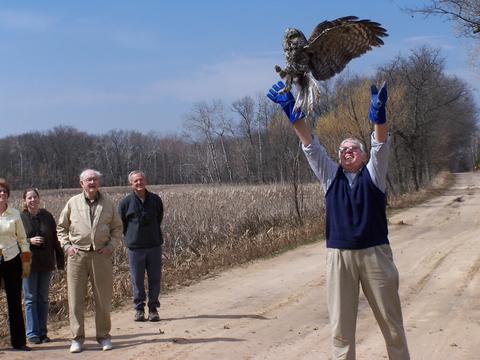 Paul Verret releasing a great gray owl