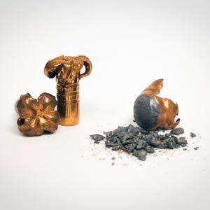 Left: A spent lead bullet with lead fragmentation debris. Right: A spent copper bullet with no fragmentation